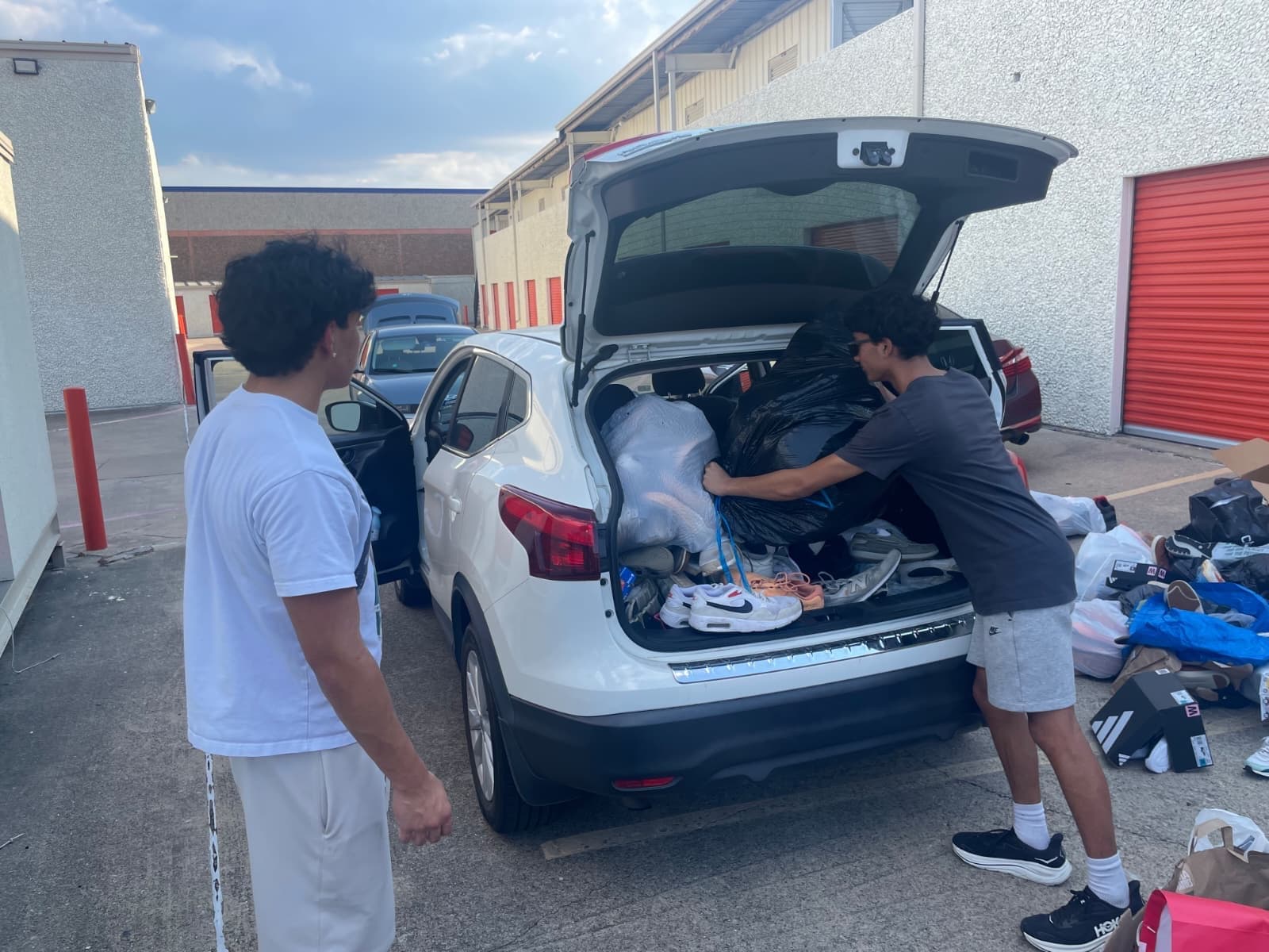 Volunteers load bags of shoes for delivery